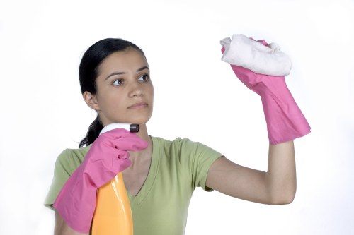 Cleaner working on hard-to-reach windows in Marylebone